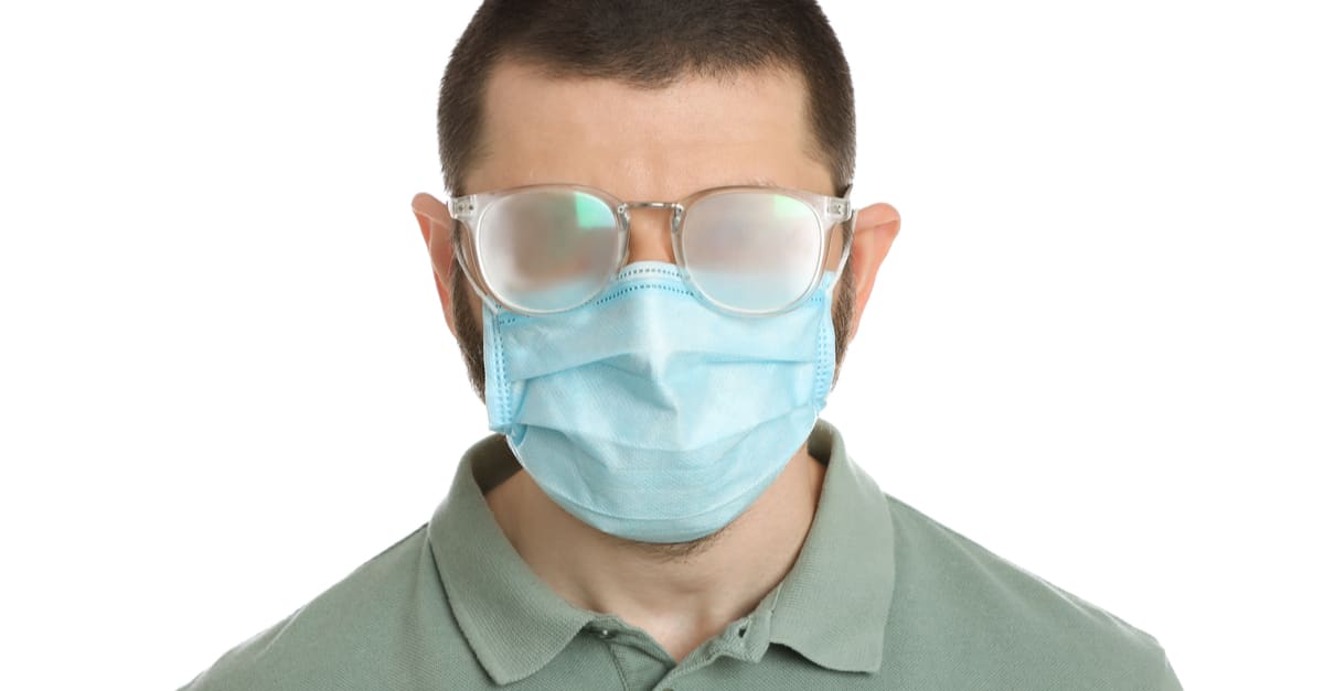 A man with foggy glasses wearing a Covid-19 mask