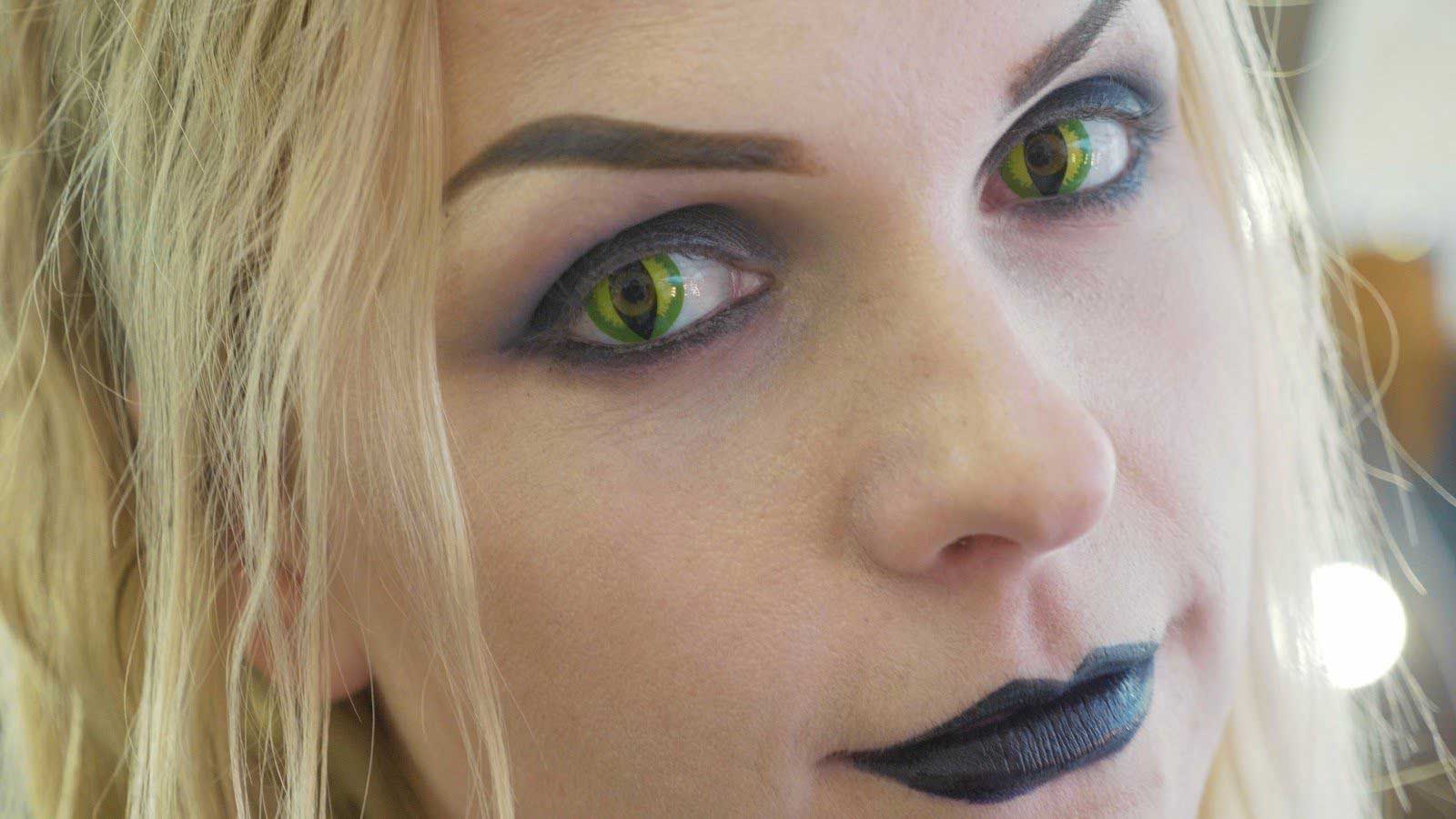 Young woman wearing special cat eye contact lenses
