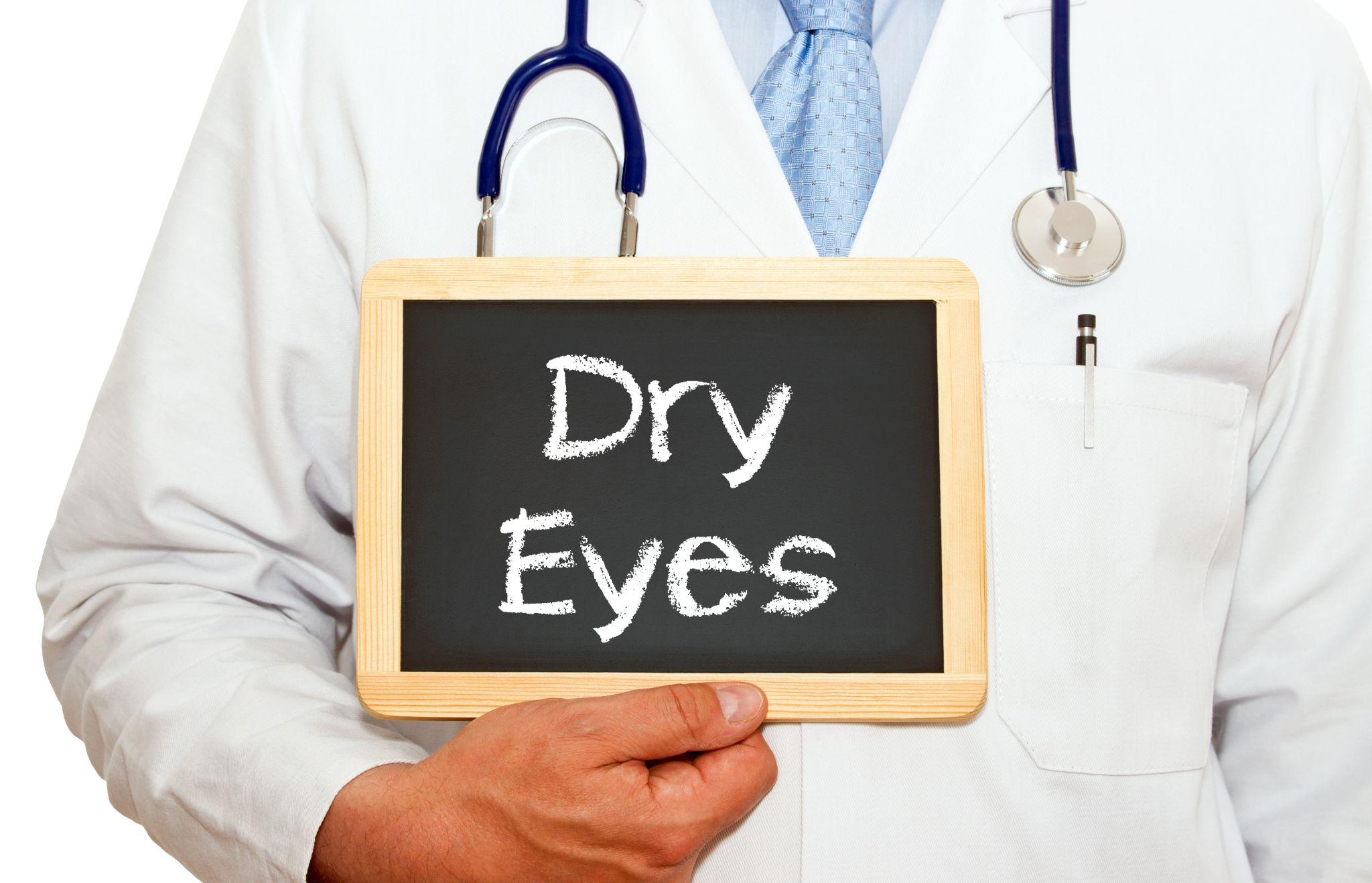 Image of a Doctor holding a sign that says 'dry eyes'