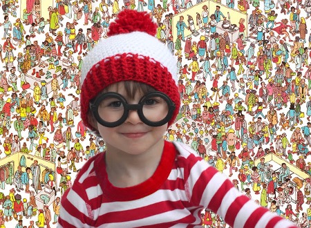 A Child wearing a where's waldo costume